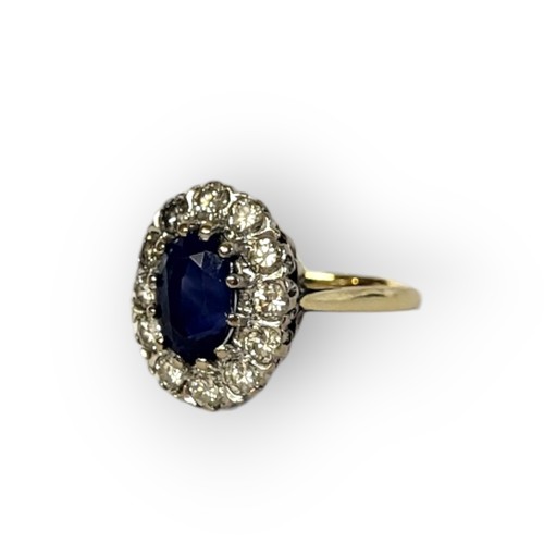 195A - AN 18CT GOLD, SAPPHIRE AND DIAMOND CLUSTER RING
The central oval cut sapphire edged with round cut d... 