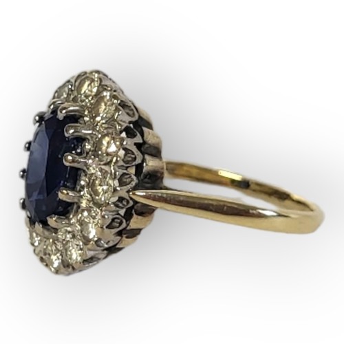 195A - AN 18CT GOLD, SAPPHIRE AND DIAMOND CLUSTER RING
The central oval cut sapphire edged with round cut d... 