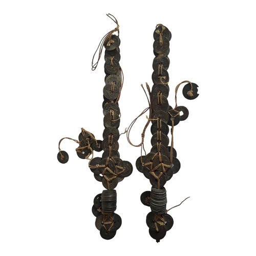 269 - A PAIR OF VINTAGE CEREMONIAL INDONESIAN DAGGERS 
Made and decorated with cash coins. 
(length 31cm)
... 