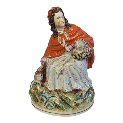 286 - STAFFORDSHIRE, A FIGURAL GROUP OF LITTLE RED RIDING HOOD
Polychrome painted with bright multicoloure... 