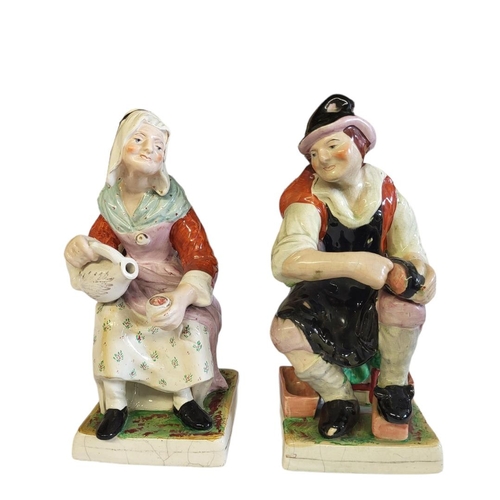 267 - STAFFORDSHIRE, A PAIR OF FIGURES BY KENT MODELLED AS THE COBBLER AND HIS WIFE 
Raised on square base... 