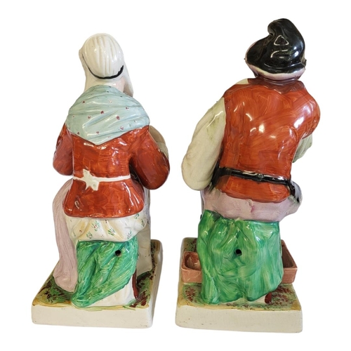 267 - STAFFORDSHIRE, A PAIR OF FIGURES BY KENT MODELLED AS THE COBBLER AND HIS WIFE 
Raised on square base... 