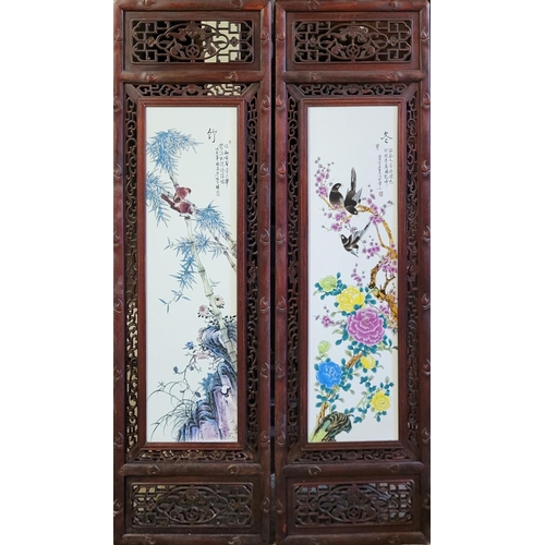 314 - A PAIR OF LATE 20TH CENTURY CHINESE HARDWOOD MOUNTED PORCELAIN PLAQUES
Depicting a group of Oriental... 