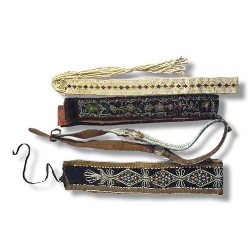 320 - A COLLECTION OF FOUR ANTIQUE NATIVE AMERICAN INDIAN BEADWORK BELTS
To include wide belt having colou... 