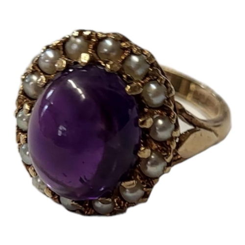 132 - AN EARLY 20TH CENTURY 9CT GOLD AMETHYST AND SEED PEARL RING
A cabochon cut amethyst edged with seed ... 