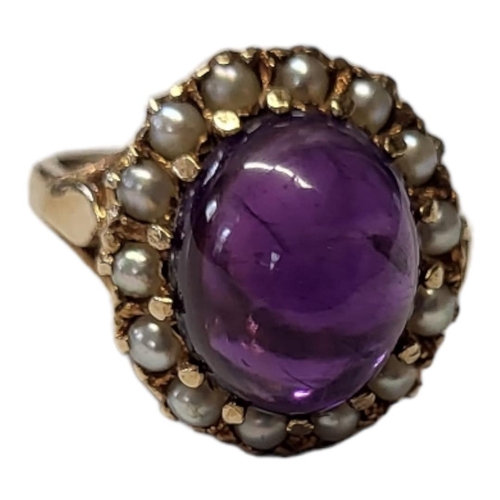 132 - AN EARLY 20TH CENTURY 9CT GOLD AMETHYST AND SEED PEARL RING
A cabochon cut amethyst edged with seed ... 