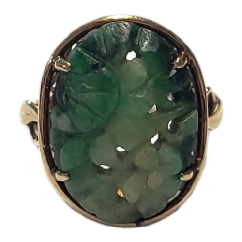 140 - AN EARLY 20TH CENTURY 9CT GOLD AND CHINESE JADE RING
A carved oval jade panel in a pierced gold moun... 