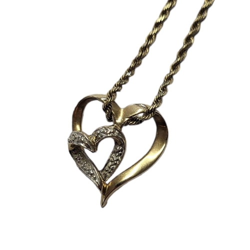 152 - A DELICATE MID 20TH CENTURY 10CT GOLD HEART PENDANT ON CHAIN NECKLACE
Stamped ‘10k’. 
(length 24cm) ... 