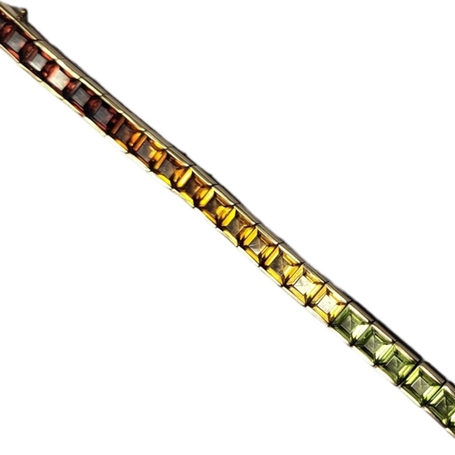 153 - AN ELEGANT MODERN DESIGN 14CT GOLD BRACELET 
With rectangular multi gem set links to include sapphir... 