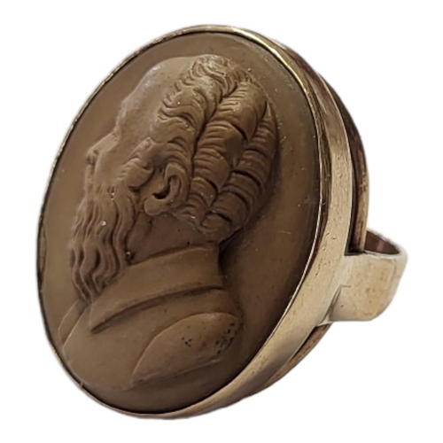 161 - AN EARLY 20TH CENTURY 9CT GOLD AND LAVA CAMEO RING
A relief carved oval portrait bust of a bearded g... 