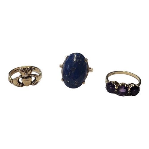 162 - A VINTAGE 9CT GOLD AND AMETHYST THREE STONE RING
Having a row of round cut amethysts, together with ... 