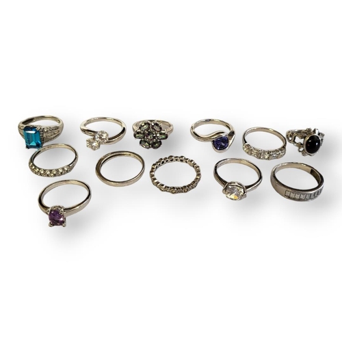 176 - A COLLECTION OF TWELVE SILVER DRESS RINGS
Various designs, set with past stones.
(size T)

Condition... 