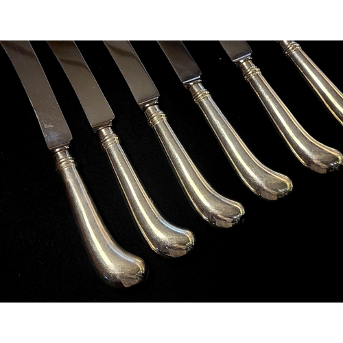 7 - A SET OF TWELVE SILVER DINNER KNIVES
Having pistol grip handles and steel blades, hallmarked Sheffie... 