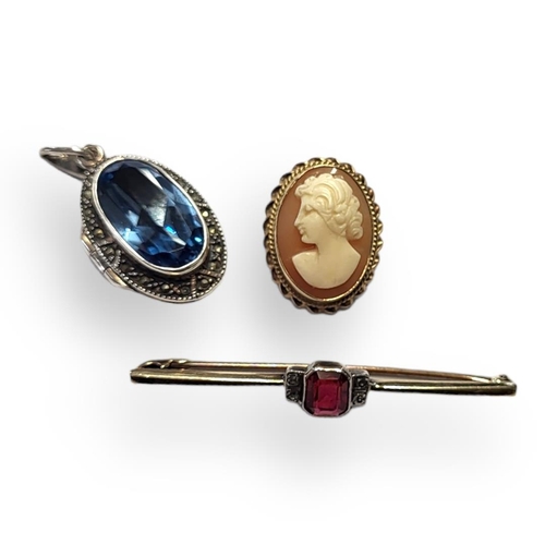 9 - AN ART DECO 9CT GOLD AND GEM SET BROOCH
The central baguette cut stone, together with 9ct gold cameo... 