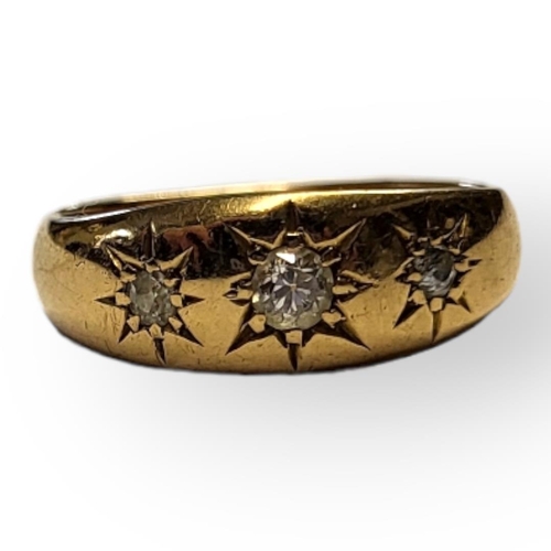 90 - AN EARLY 20TH CENTURY 18CT GOLD AND DIAMOND THREE STONE RING
Having three graduated round cut diamon... 