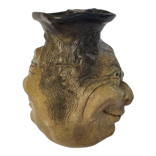 247 - AN EARLY 20TH CENTURY MARTIN BROTHERS STYLE STONEWARE EWER
Moulded with grotesque smiling figure, se... 