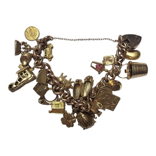 111 - A VINTAGE 9CT GOLD CHARM BRACELET
Having twenty 9ct gold charms including a bucket, ballet shoes, bo... 