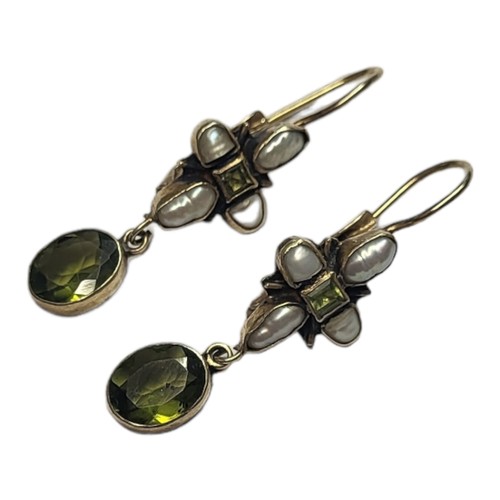 166 - A PAIR OF EARLY 20TH CENTURY YELLOW METAL, PERIDOT AND SEED PEARL EARRINGS
Of cruciform design with ... 