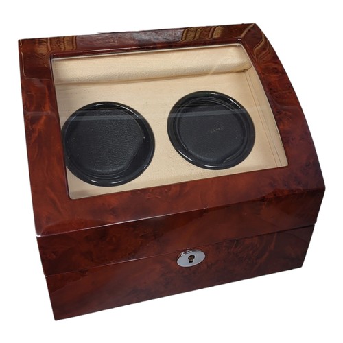 204 - HILLWOOD OF LONDON, A GLAZED WALNUT WATCH WINDER
The fitted soft leather interior having two winding... 