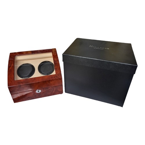 204 - HILLWOOD OF LONDON, A GLAZED WALNUT WATCH WINDER
The fitted soft leather interior having two winding... 