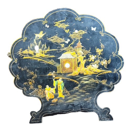 253 - A VICTORIAN JAPANESQUE LACQUER DECORATED CARTOUCHE FORM SCREEN 
Having parcel gilt figural scenes, s... 