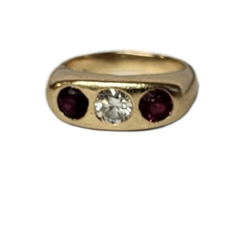 34A - A 14CT GOLD, DIAMOND AND RUBY THREE STONE RING
The central round cut diamond flanked with rubies in ... 