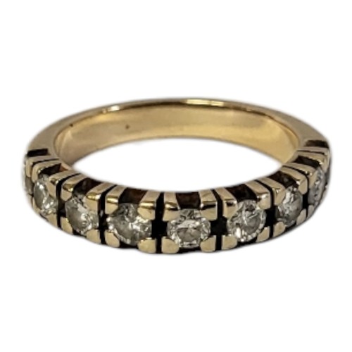 21A - A YELLOW METAL AND DIAMOND HALF ETERNITY RING
Having a row of round cut diamonds.
(approx total diam... 