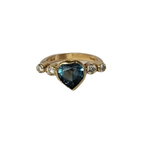 33A - AN 18CT GOLD, DIAMOND AND BLUE TOPAZ RING
The central heart cut stone flanked with diamonds.
(topaz ... 