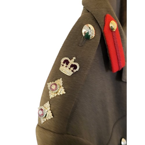 16 - A BRITISH ROYAL ARTILLERY SERVICE DRESS UNIFORM
The epaulettes having pips and high ranking badges, ... 