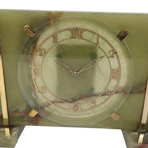 59 - A MID CENTURY GREEN ONYX RECTANGULAR MANTLE CLOCK
With gilt brass mounts, circular dial with Arabic ... 