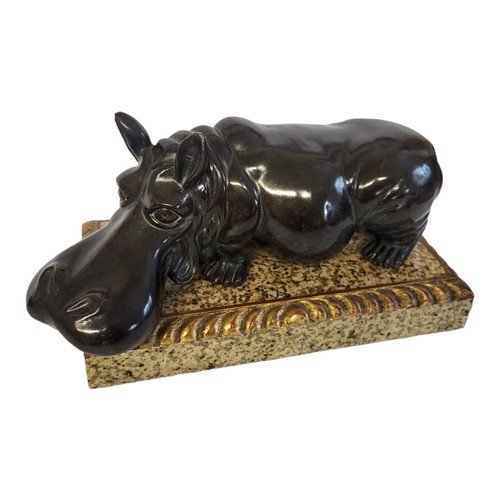 61 - A MID CENTURY BRONZE AND MARBLE HIPPOPOTAMUS
Standing pose with exaggerated features on a rectangula... 