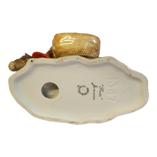 121 - A RARE BESWICK POTTERY FIGURAL GROUP, A YOUNG JAMAICAN GIRL SITTING ON A DONKEY
Titled ‘Susie Jamaic... 