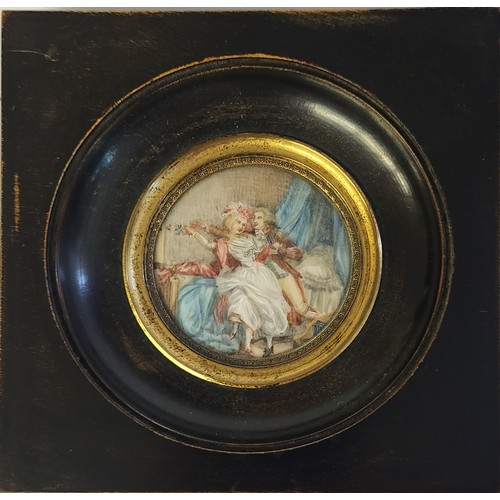 463 - A 19TH CENTURY CIRCULAR MINIATURE PAINTING ON IVORY, BEDROOM SCENE WITH COURTING COUPLE
In an ebonis... 