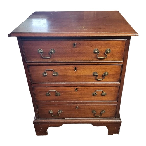 520 - AN EARLY 20TH CENTURY GEORGIAN STYLE MAHOGANY CHEST OF FOUR DRAWERS
With brass fittings, on bracket ... 