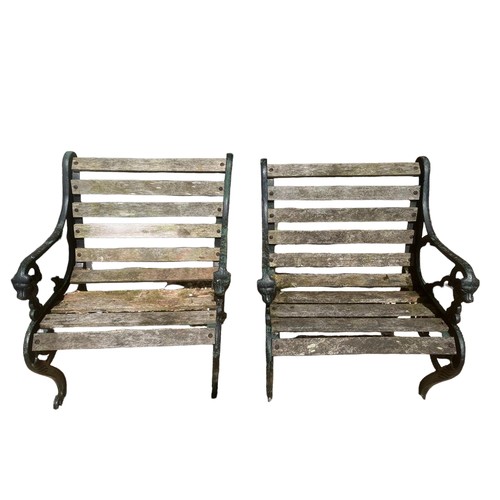 562 - A PAIR OF REGENCY STYLE CAST IRON GARDEN ARMCHAIRS
With pierced side and lion masks, on scroll feet.... 