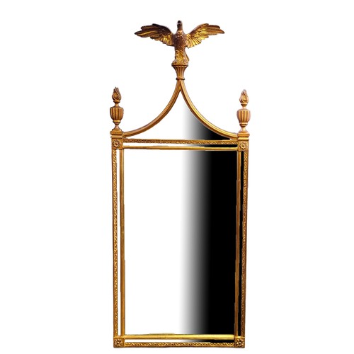 553 - AN 18TH CENTURY STYLE GILT FRAMED MIRROR
With eagle crest and torches above sectional silvered plate... 