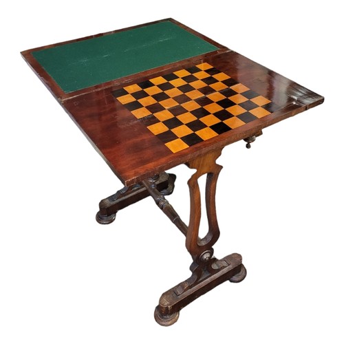 577 - A VICTORIAN MAHOGANY FOLD OVER GAMES TABLE
Having an inlaid chess board and green baize lined interi... 