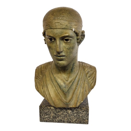 57A - A CHARIOTTIER OF DELPHI BRONZED TERRACOTTA BUST AFTER GREEK-HELLEUIC ANTIQUITIES, raised on marble b... 