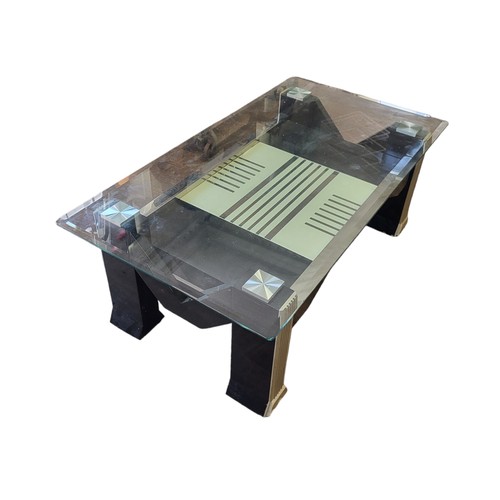 557 - AN ART DECO DESIGN GLASS AND CHROME COFFEE TABLE, with stylised under-tier.

Condition good.
120 x 6... 