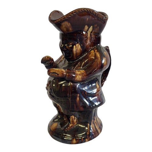 207 - A VICTORIAN STAFFORDSHIRE TOBY JUG
Brown treacle glaze modelled as the Snuff Taker.
(approx 24cm)

C... 