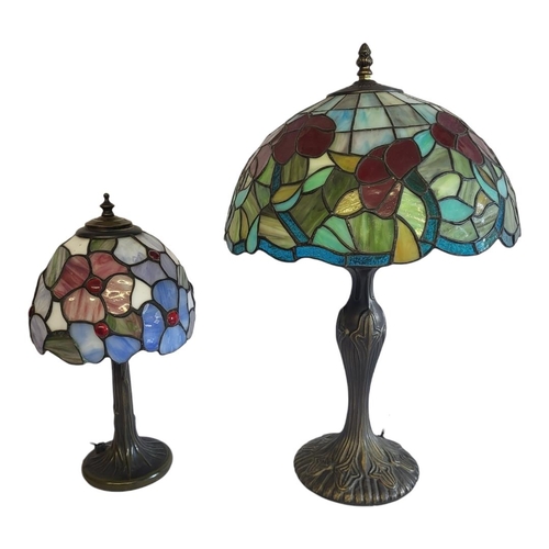 243 - TWO 20TH CENTURY STAINED GLASS LAMPS
Tiffany design, with mushroom form shades and filled bronze bas... 