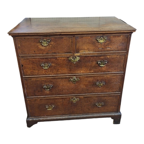 502 - AN 18TH CENTURY OAK CHEST OF TWO SHORT ABOVE THREE LONG DRAWERS
With brass handles, on bracket feet.... 