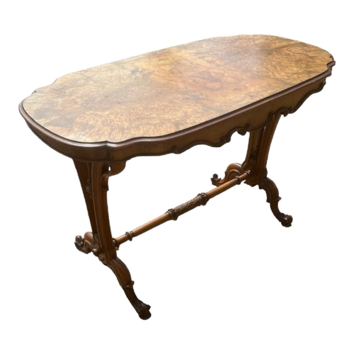 512 - A VICTORIAN ART NOUVEAU PERIOD BURR AND FIGURED WALNUT CENTRE TABLE
The cartouche top above a shaped... 