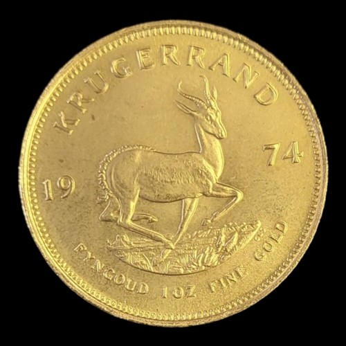 56 - A SOUTH AFRICAN 22CTC GOLD 1OZ KRUGERRAND COIN, DATED 1974 
With portrait but and springbok to rever... 