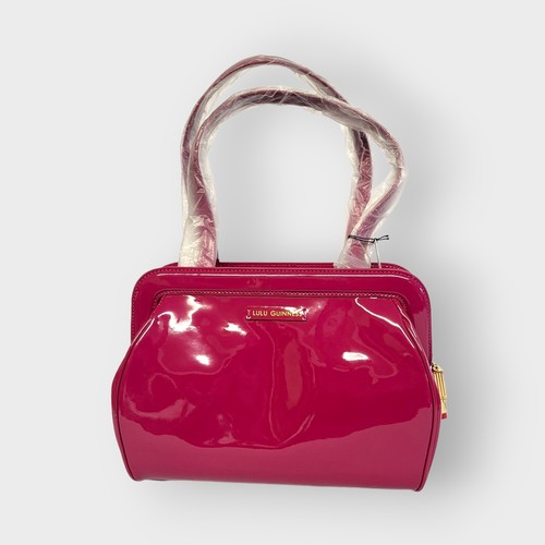 269A - LULU GUINNESS, A MEDIUM PATENT RASPBERRY LEATHER PAULA HANDBAG
With black and red interior, bearing ... 