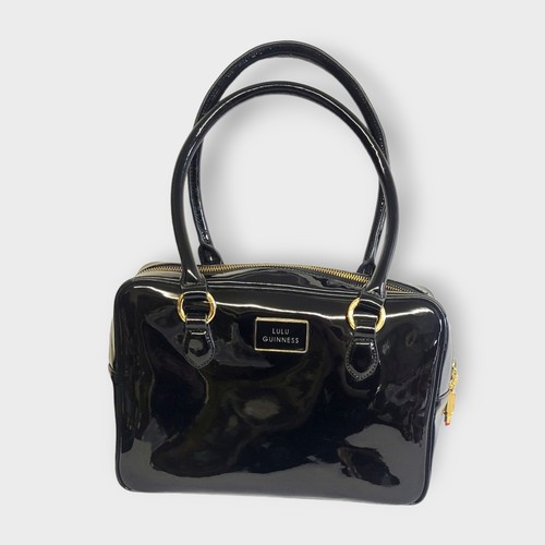 272 - LULU GUINNESS, A BLACK PATENT LEATHER SHOULDER BAG
Wth gilt metal mounts, faux lipstick clasps, red ... 