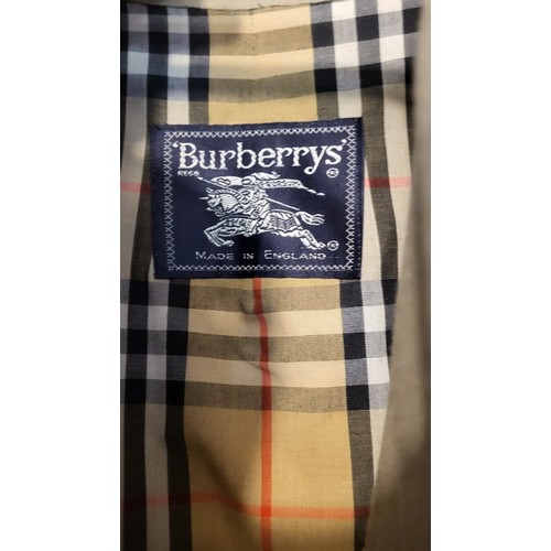 279A - BURBERRYS, A VINTAGE LADIES’ TRENCH COAT 
Tan colour with traditional pattern to interior, bearing l... 