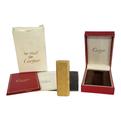 24 - LES MUST DE CARTIER, A VINTAGE GOLD PLATED CYLINDRICAL CIGARETTE LIGHTER
With textured finish, marke... 