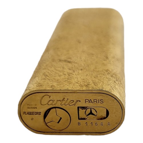 24 - LES MUST DE CARTIER, A VINTAGE GOLD PLATED CYLINDRICAL CIGARETTE LIGHTER
With textured finish, marke... 