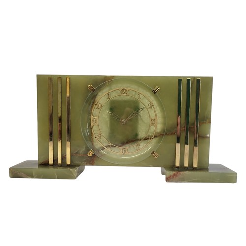 352 - A MID CENTURY GREEN ONYX RECTANGULAR MANTLE CLOCK
With gilt brass mounts, circular dial with Arabic ... 